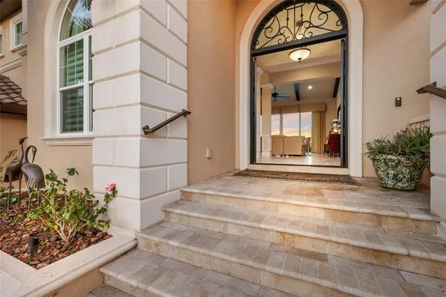 a large white kitchen with a large window and stainless steel appliances