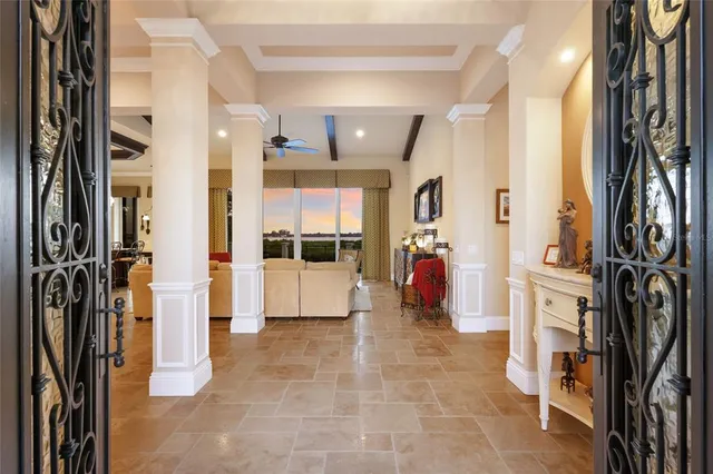 a view of a livingroom with furniture and an entrance to other room