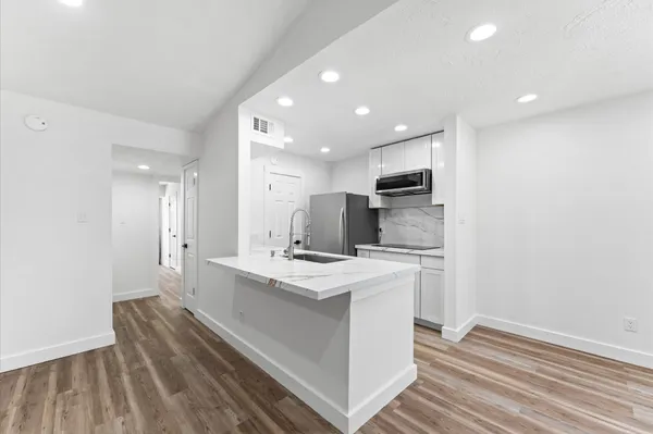 a kitchen with a sink stainless steel appliances and cabinets