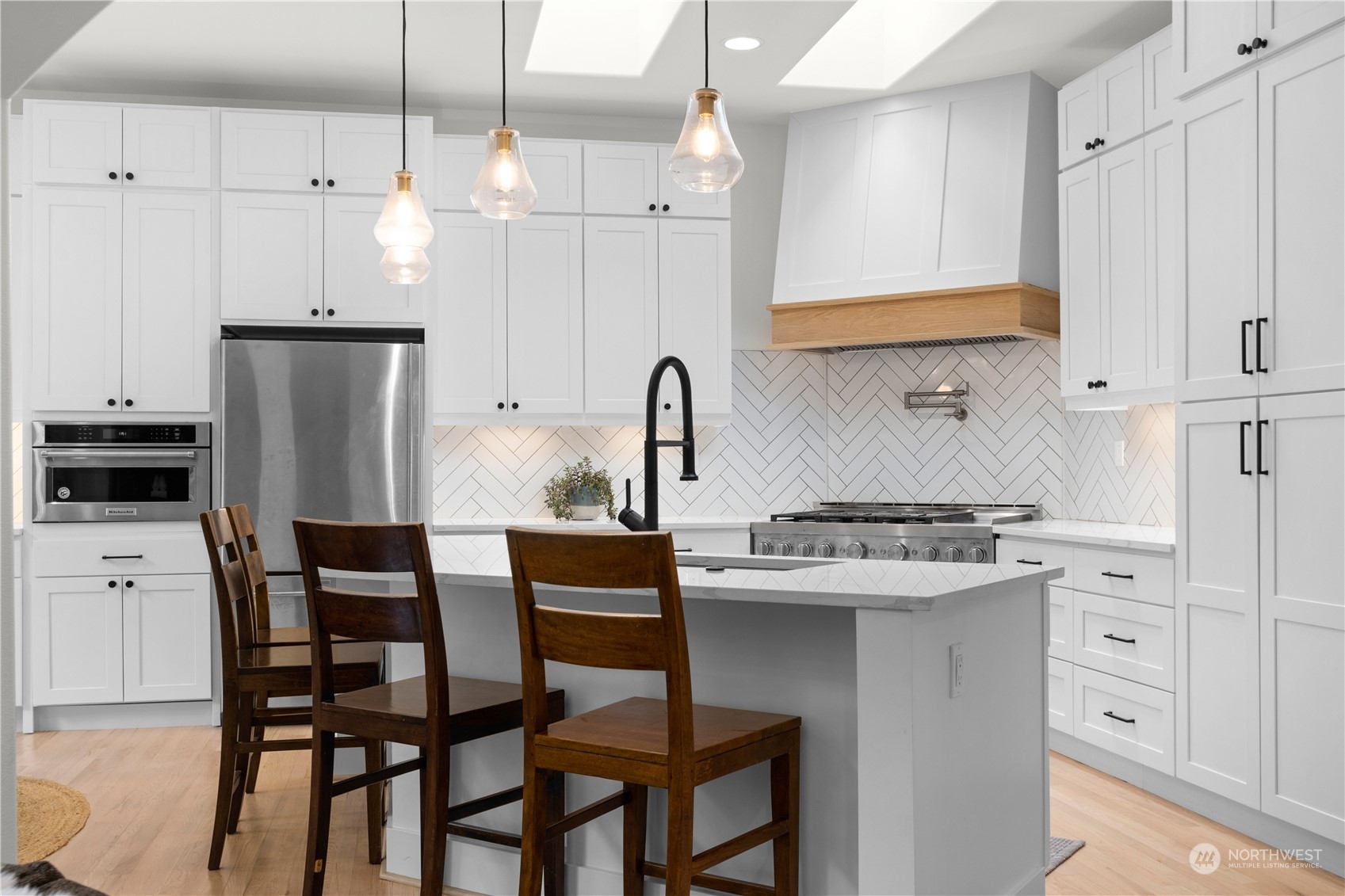 20919 29th Avenue Southeast Bothell, WA 98021 - Photo 12 of 32 a kitchen with stainless steel appliances a white table chairs and a refrigerator