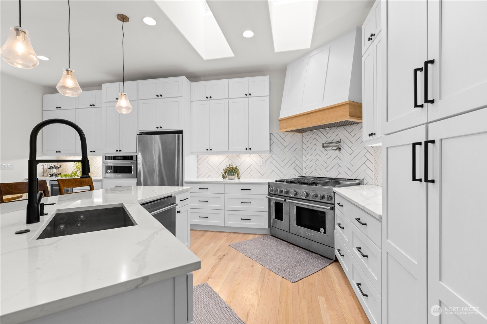 20919 29th Avenue Southeast Bothell, WA 98021 - Photo 14 of 32 a kitchen with stainless steel appliances granite countertop a sink a stove and a refrigerator