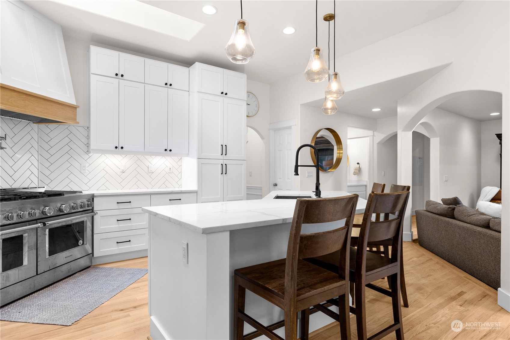 20919 29th Avenue Southeast Bothell, WA 98021 - Photo 17 of 32 a kitchen with a dining table chairs and white cabinets