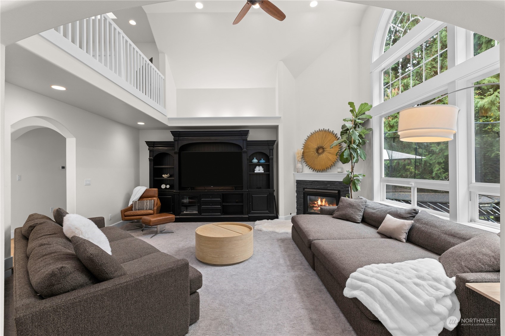 20919 29th Avenue Southeast Bothell, WA 98021 - Photo 9 of 32 a living room with furniture a fireplace and a large window
