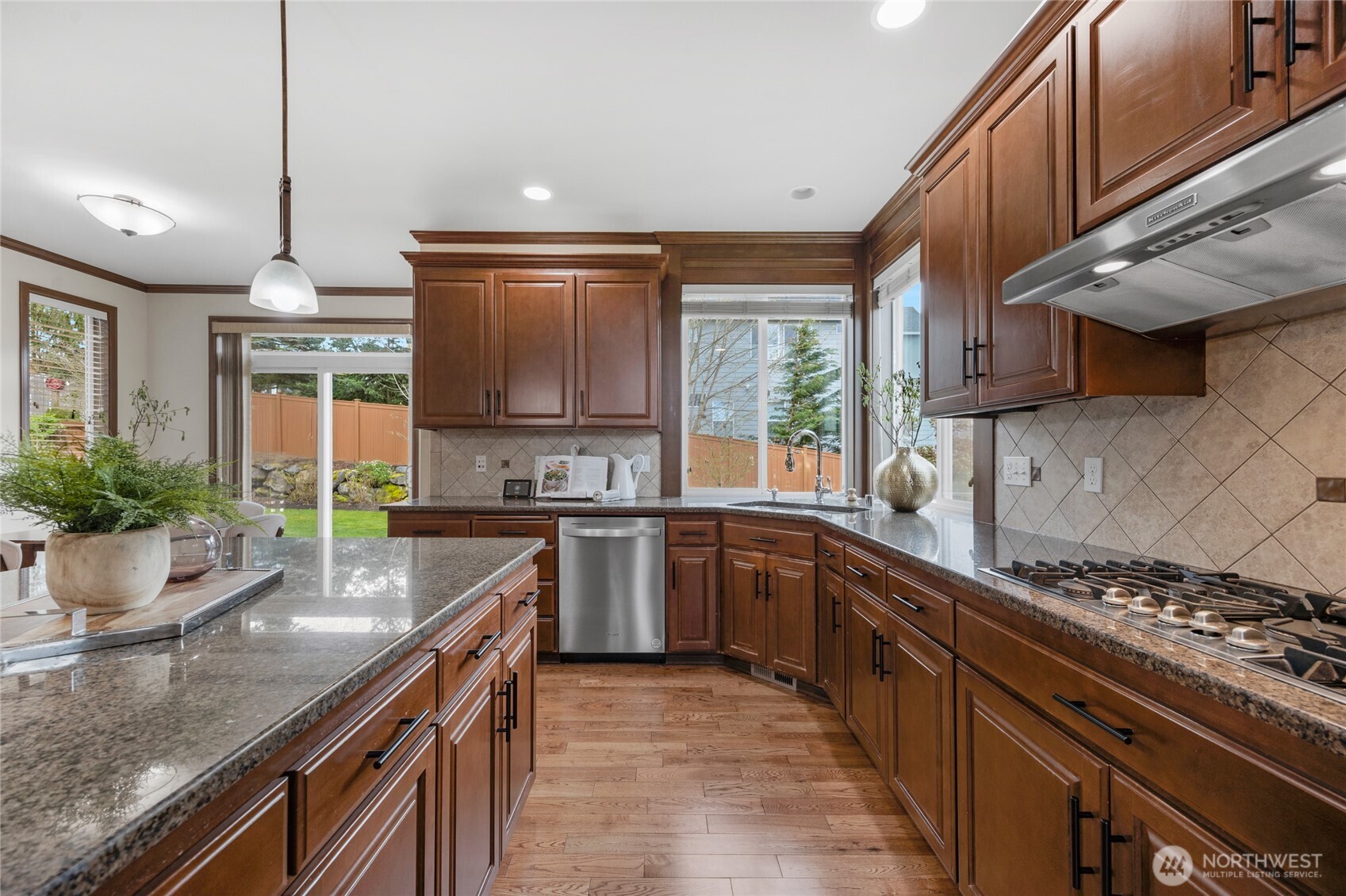 4326 221st Street Southeast Bothell, WA 98021 - Photo 13 of 34 a kitchen with kitchen island granite countertop a sink a counter space stainless steel appliances and cabinets