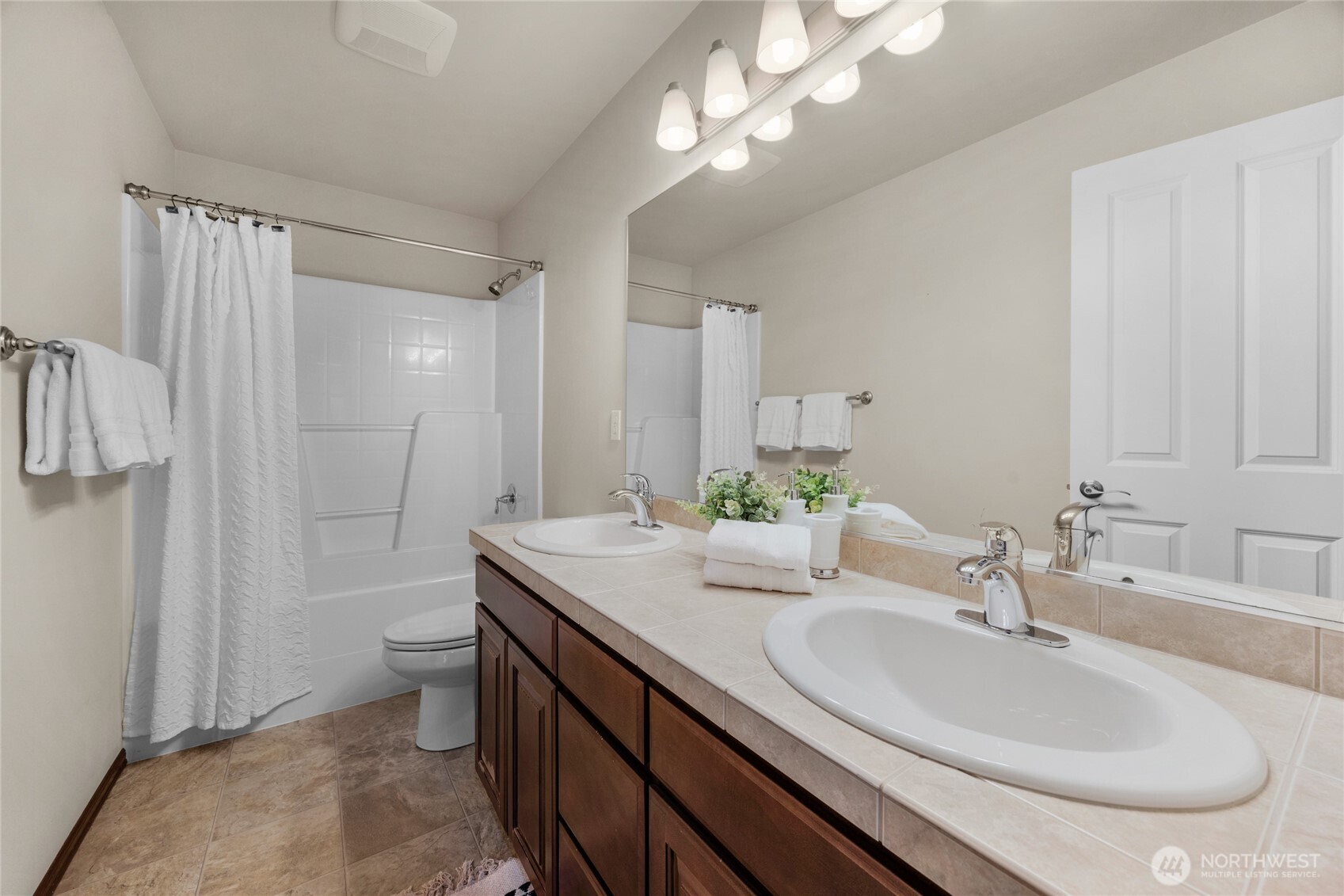4326 221st Street Southeast Bothell, WA 98021 - Photo 21 of 34 a bathroom with a granite countertop sink a toilet and a mirror