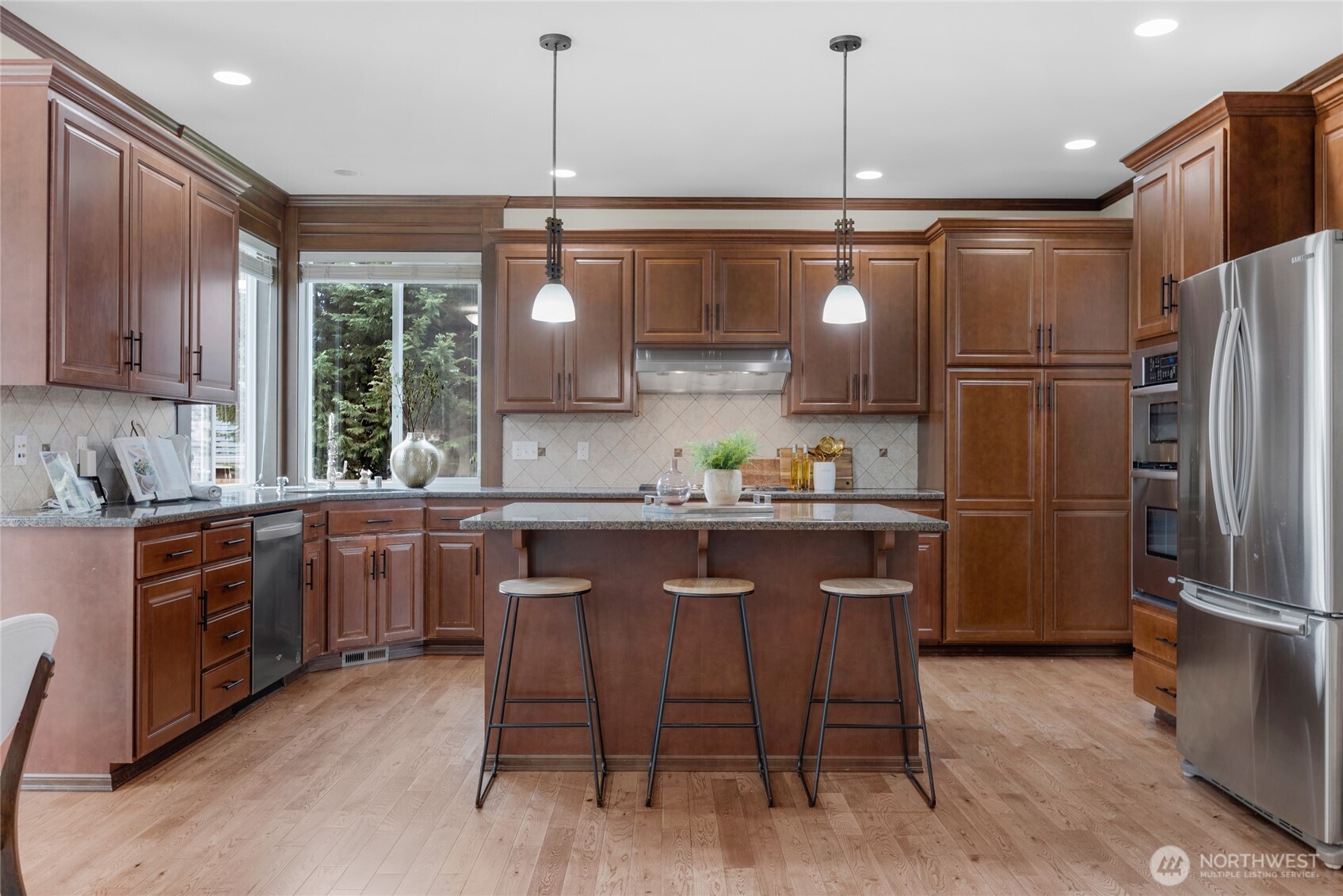 4326 221st Street Southeast Bothell, WA 98021 - Photo 10 of 34 a kitchen with a refrigerator a sink and dishwasher with wooden floor