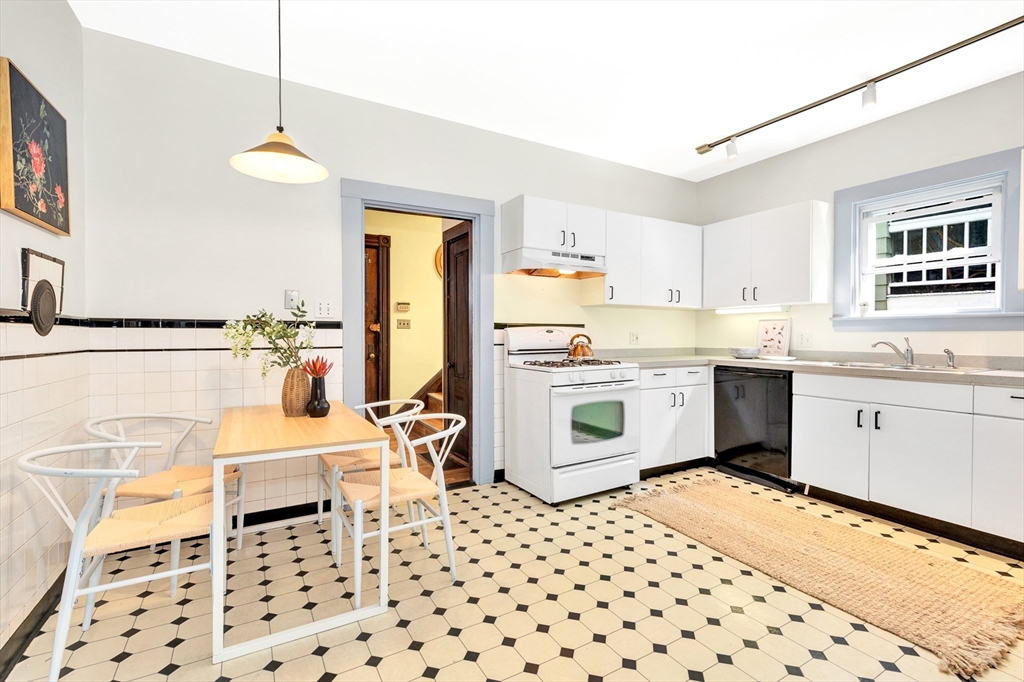 42 St Rose Street Boston, MA 02130 - Photo 11 of 41 a kitchen with a sink a stove a table and chairs