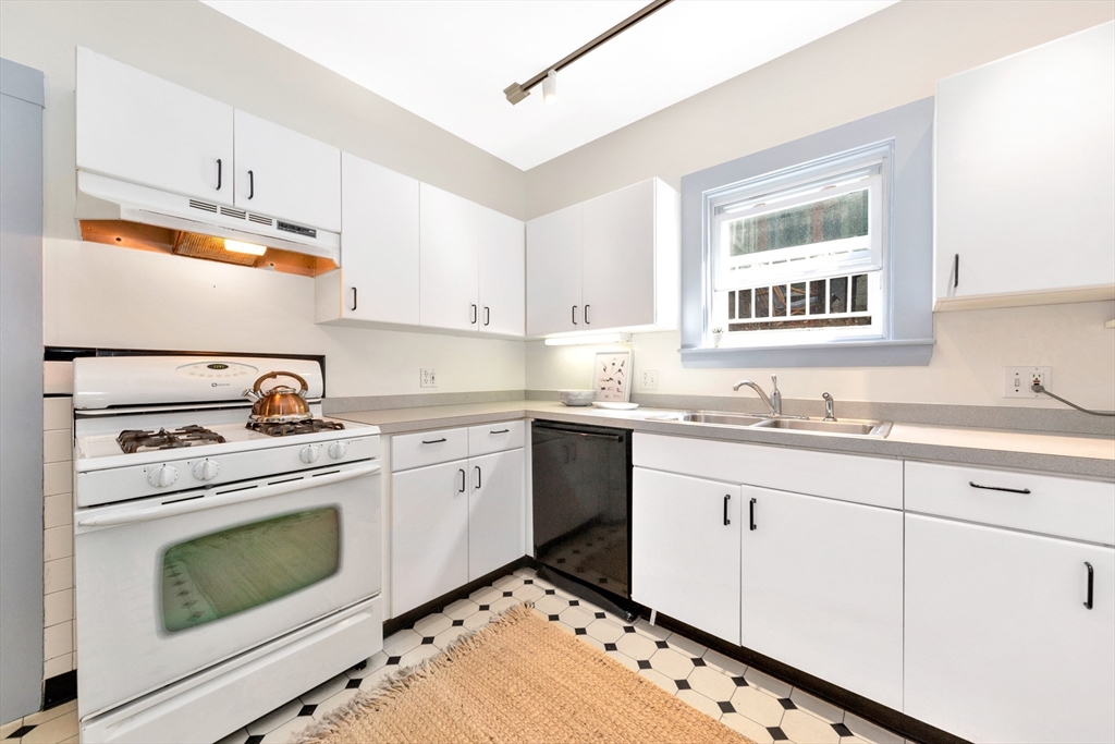 42 St Rose Street Boston, MA 02130 - Photo 12 of 41 a kitchen with granite countertop cabinets stainless steel appliances and a sink