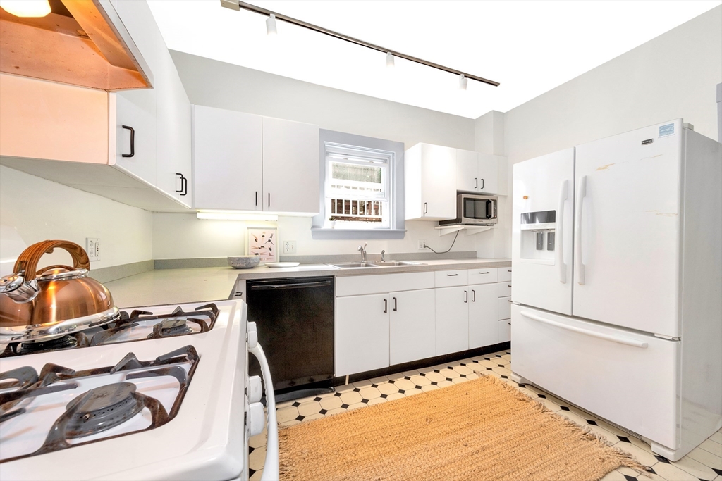42 St Rose Street Boston, MA 02130 - Photo 13 of 41 a kitchen with a sink stove and refrigerator