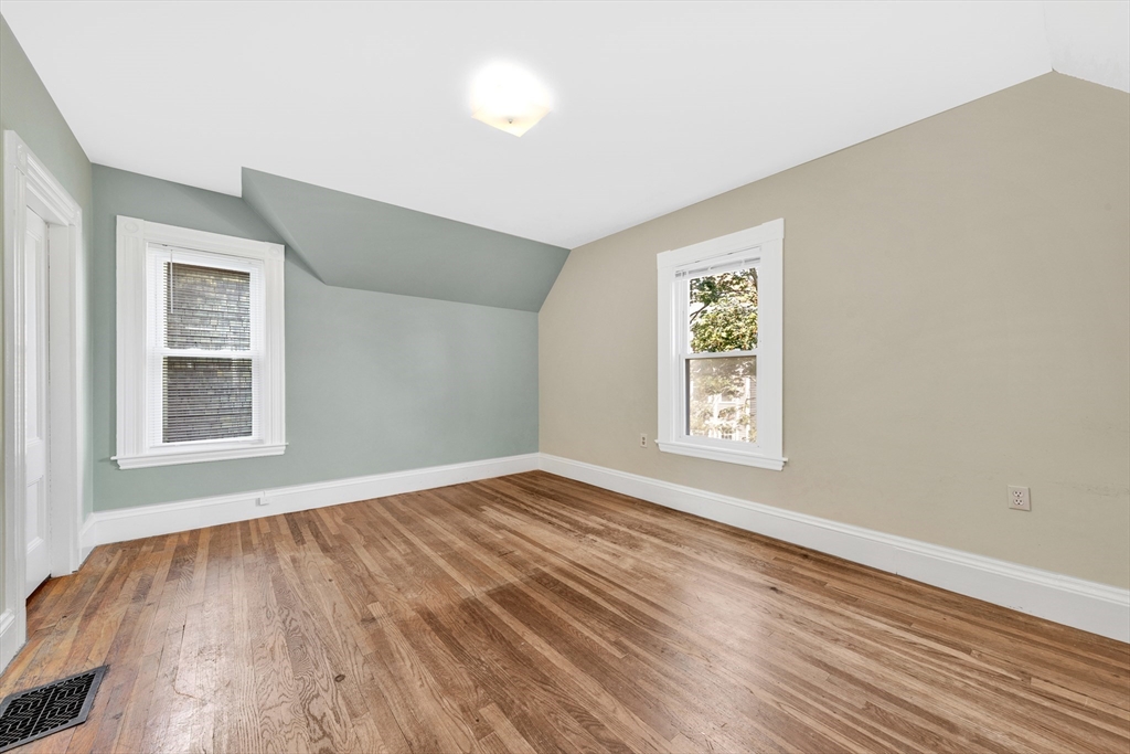 42 St Rose Street Boston, MA 02130 - Photo 20 of 41 a view of an empty room with wooden floor and a window