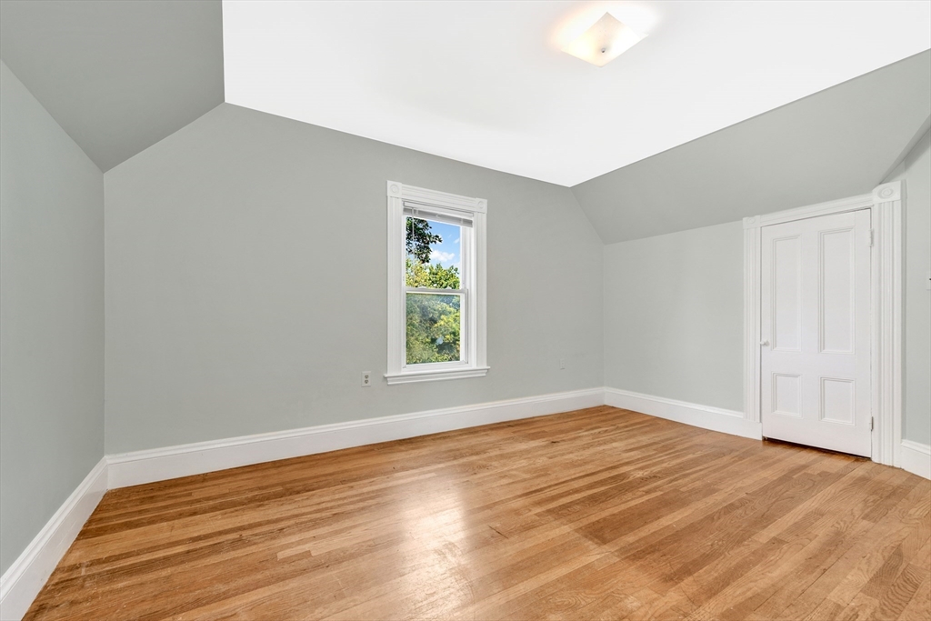 42 St Rose Street Boston, MA 02130 - Photo 22 of 41 an empty room with wooden floor and windows