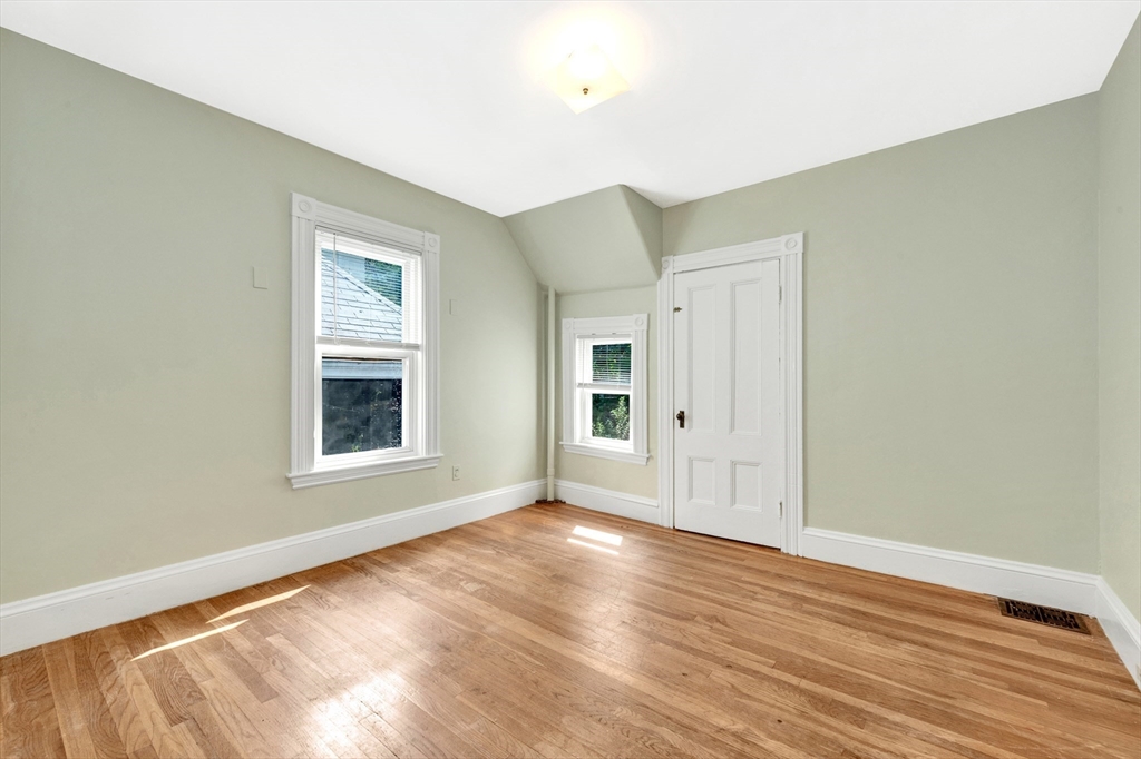42 St Rose Street Boston, MA 02130 - Photo 23 of 41 an empty room with wooden floor and windows