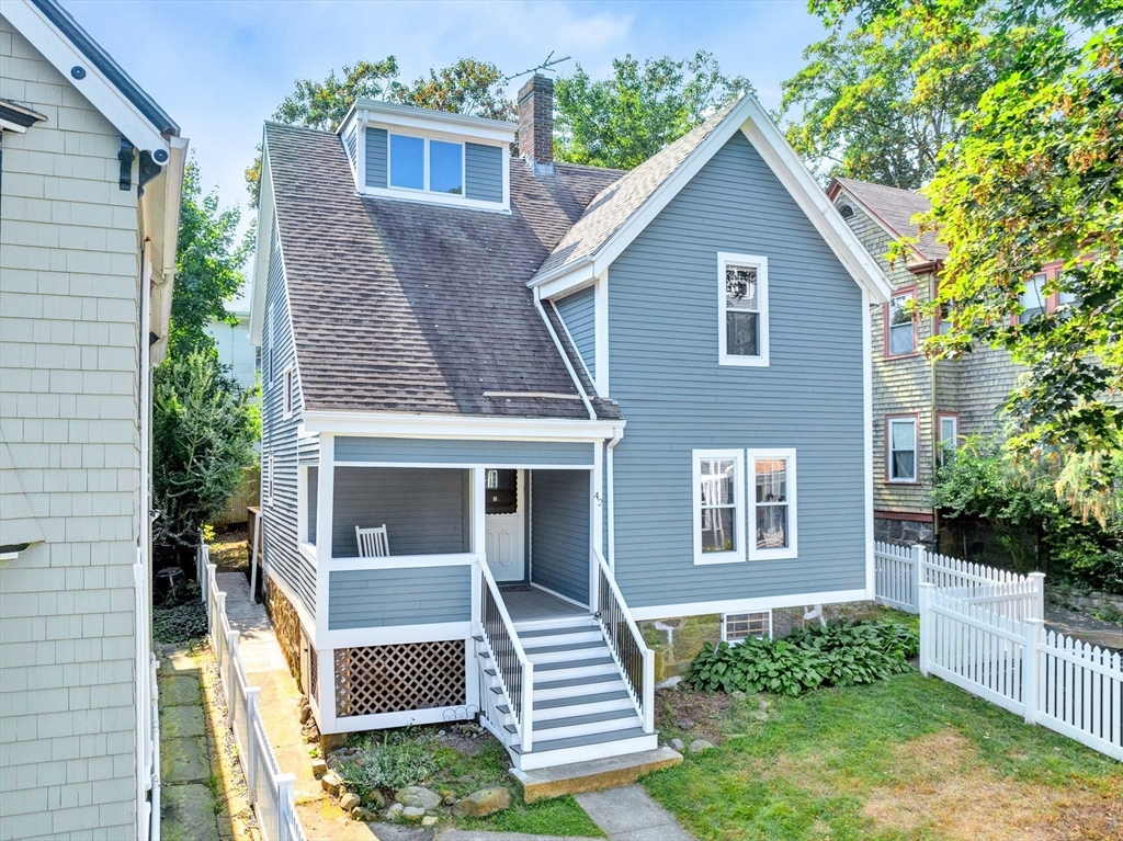 42 St Rose Street Boston, MA 02130 - Photo 32 of 41 a front view of a house with a yard