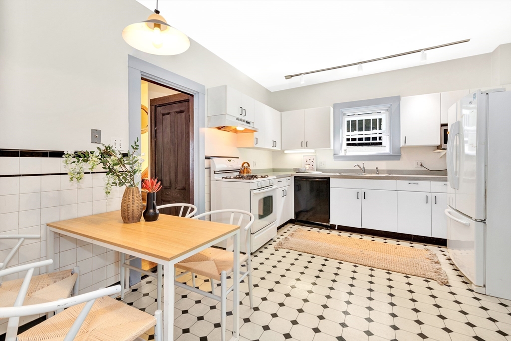 42 St Rose Street Boston, MA 02130 - Photo 10 of 41 a kitchen with a sink a stove and chairs