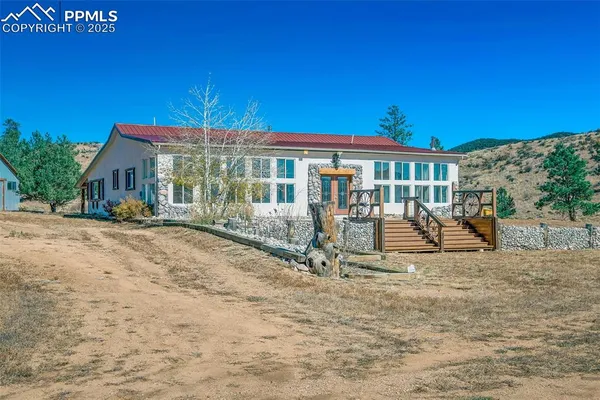 a view of a house with backyard porch and sitting area