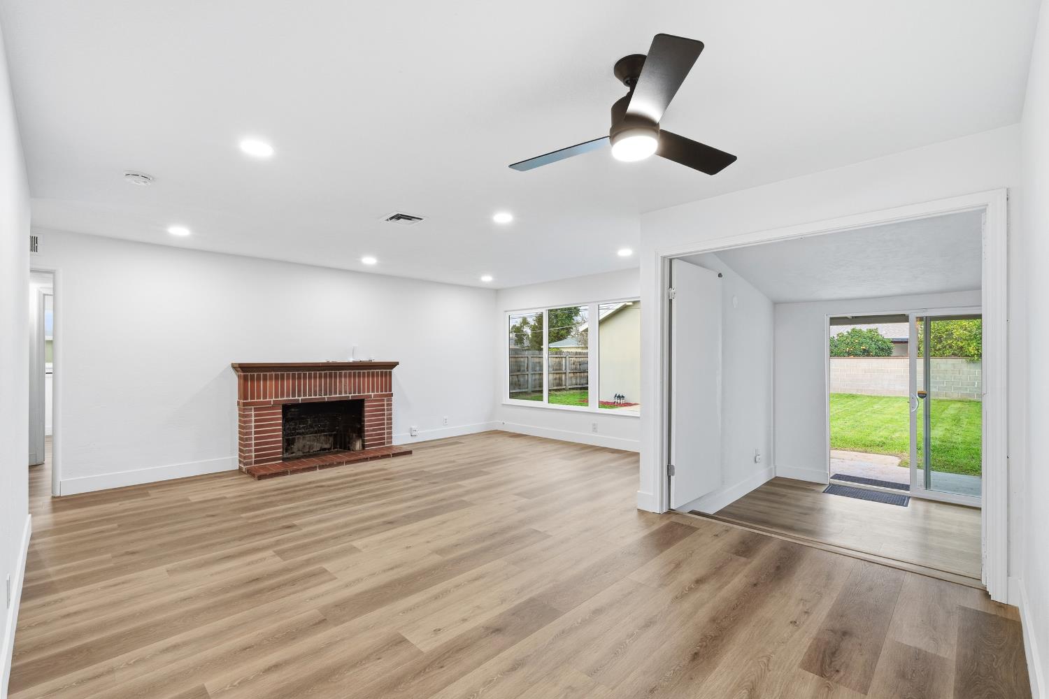 3473 East Dayton Avenue Fresno, CA 93726 - Photo 12 of 49 an empty room with windows and fireplace
