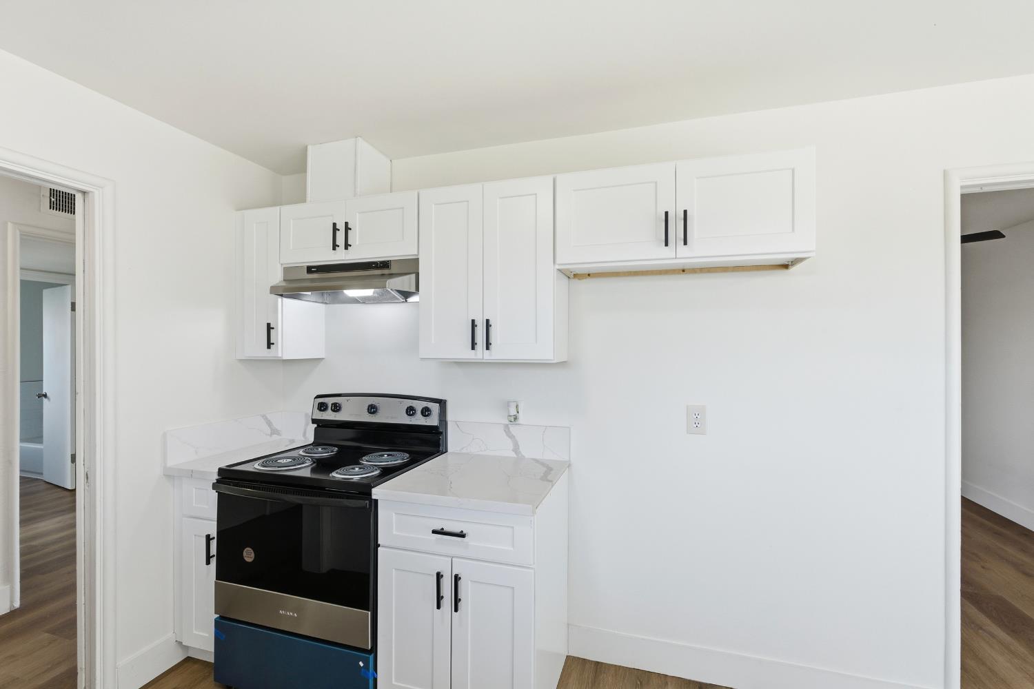 3473 East Dayton Avenue Fresno, CA 93726 - Photo 18 of 49 a kitchen with stainless steel appliances granite countertop white cabinets and a stove