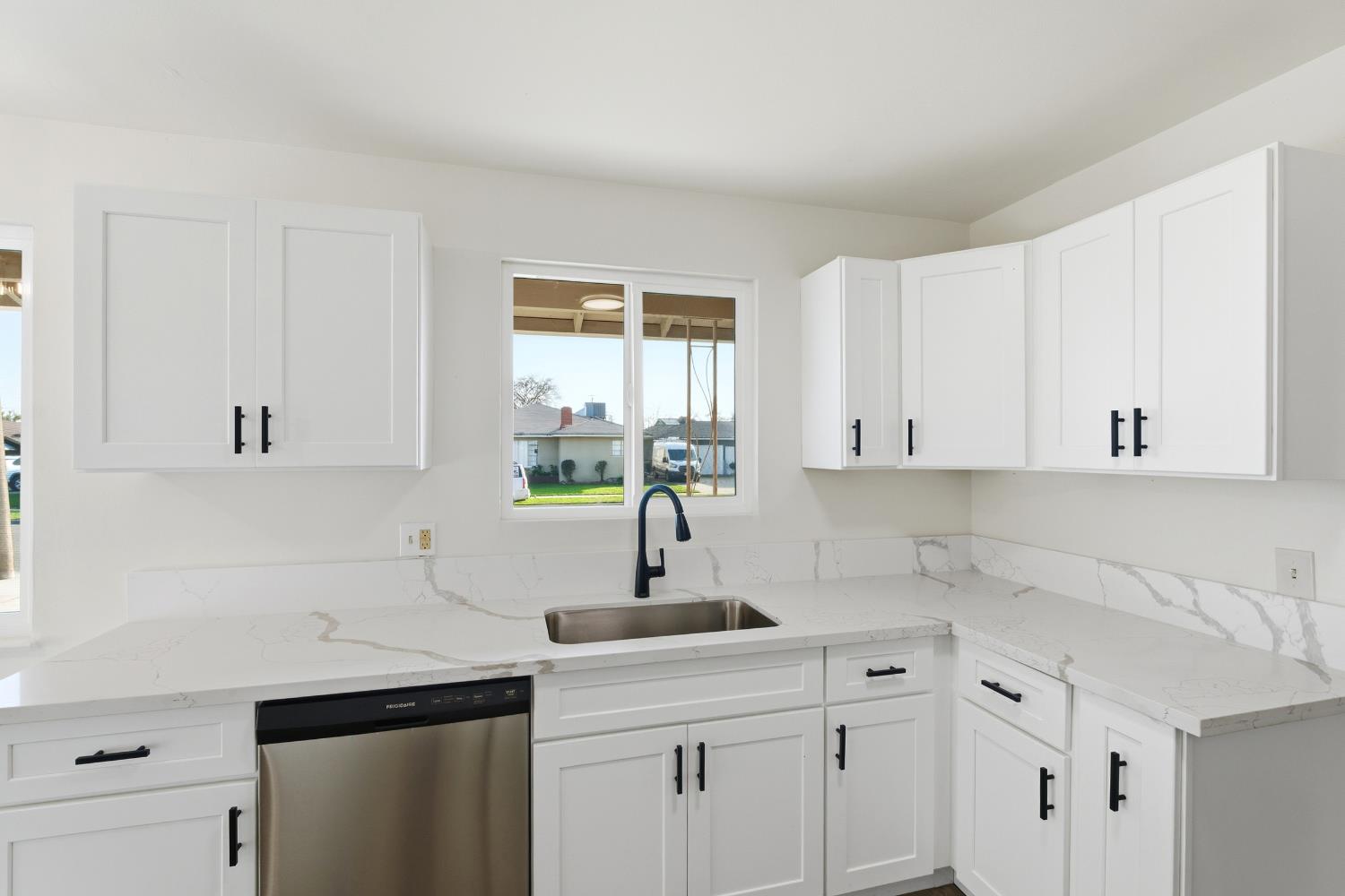 3473 East Dayton Avenue Fresno, CA 93726 - Photo 19 of 49 a kitchen with a sink cabinets and window