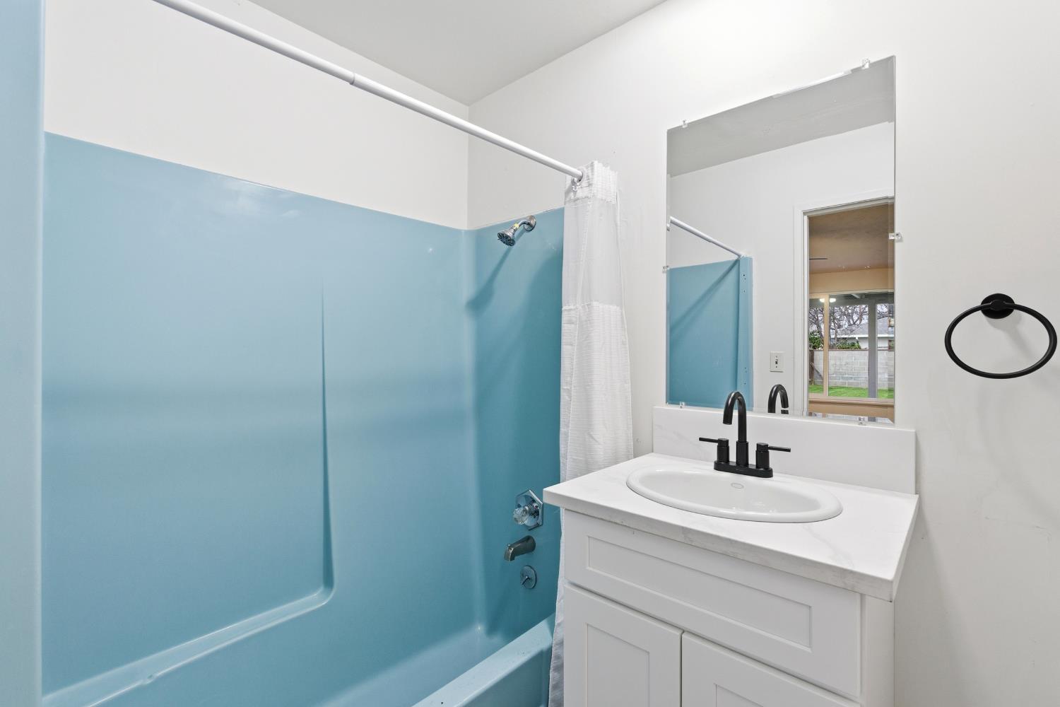 3473 East Dayton Avenue Fresno, CA 93726 - Photo 23 of 49 a bathroom with a sink and a mirror