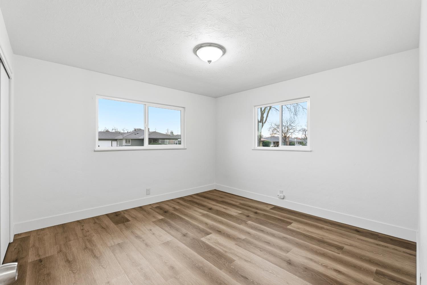 3473 East Dayton Avenue Fresno, CA 93726 - Photo 24 of 49 a view of empty room with wooden floor