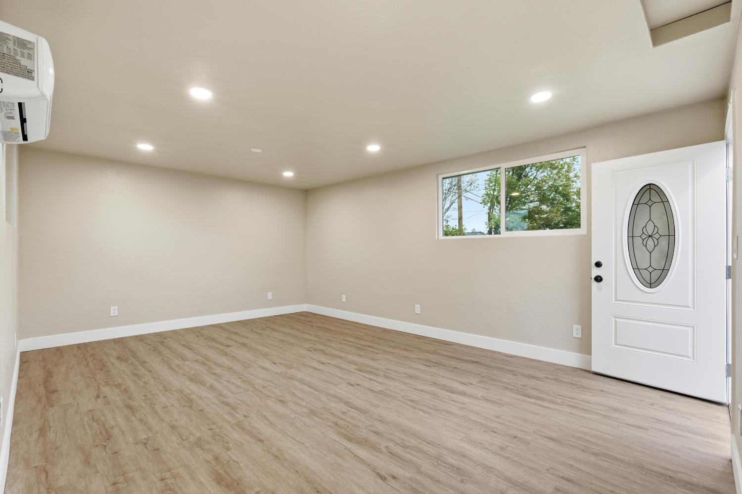 3473 East Dayton Avenue Fresno, CA 93726 - Photo 34 of 49 an empty room with wooden floor and window