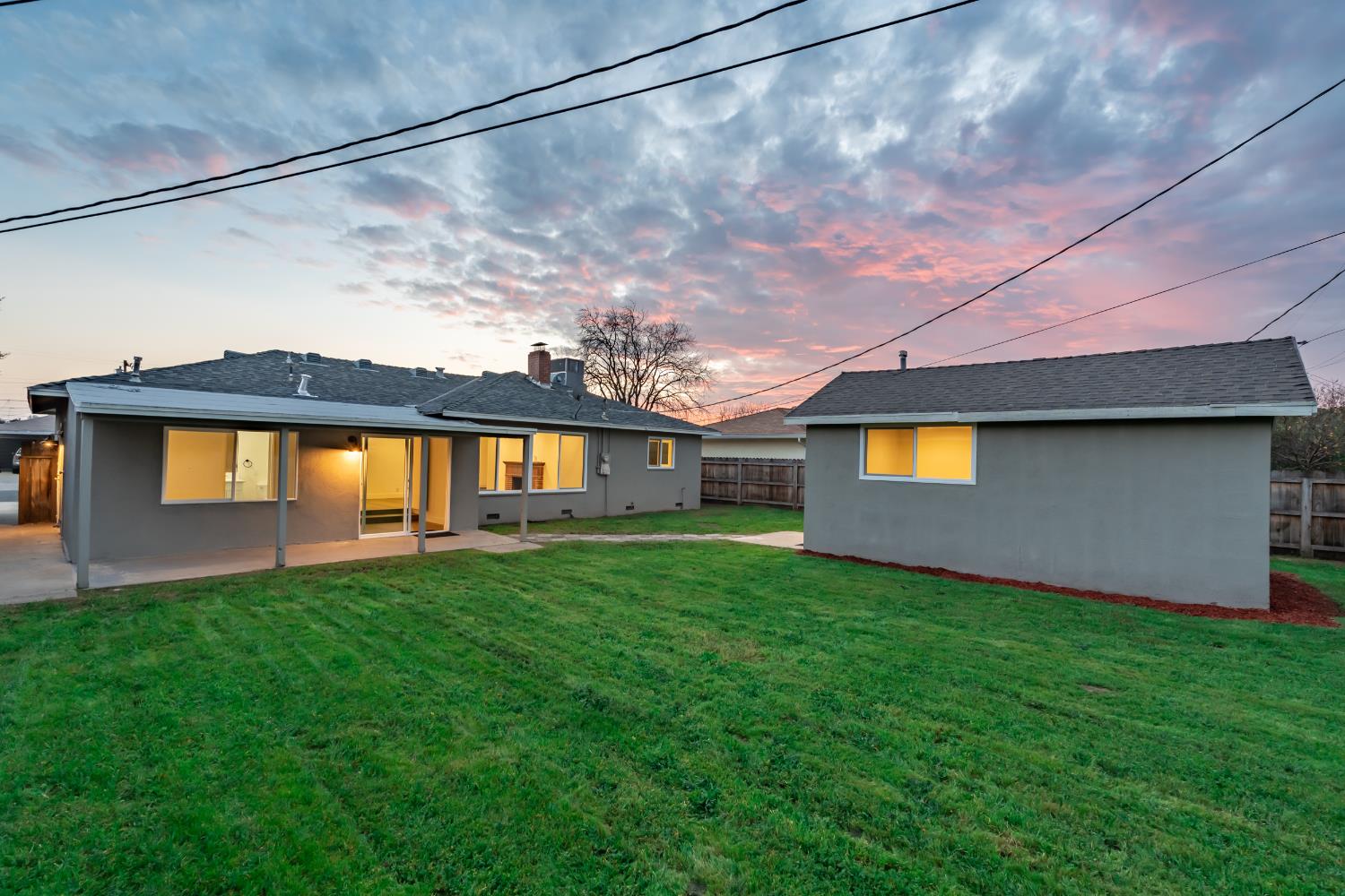 3473 East Dayton Avenue Fresno, CA 93726 - Photo 7 of 49 a front view of a house with a yard and a garage
