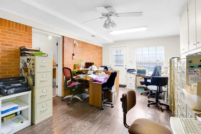 a view of a livingroom with workspace and a window