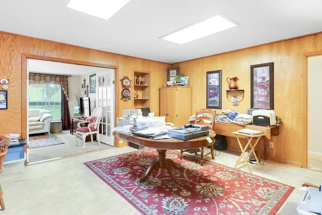 a living room with furniture a rug and a table