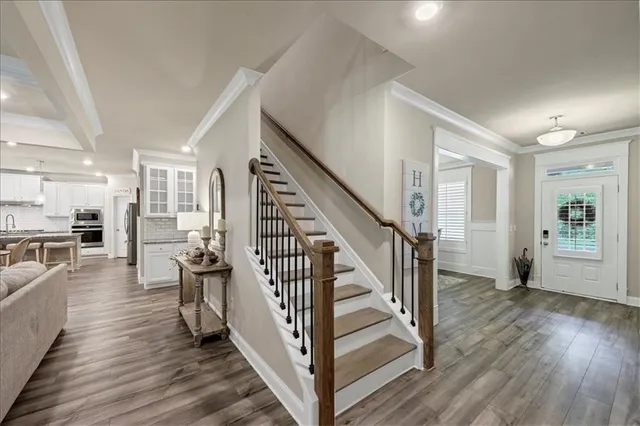 a view of entryway and hall with wooden floor