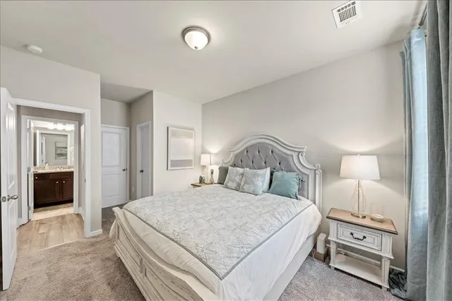 a bedroom with a bed and a night stand