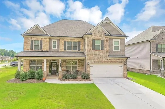 a front view of a house with a yard