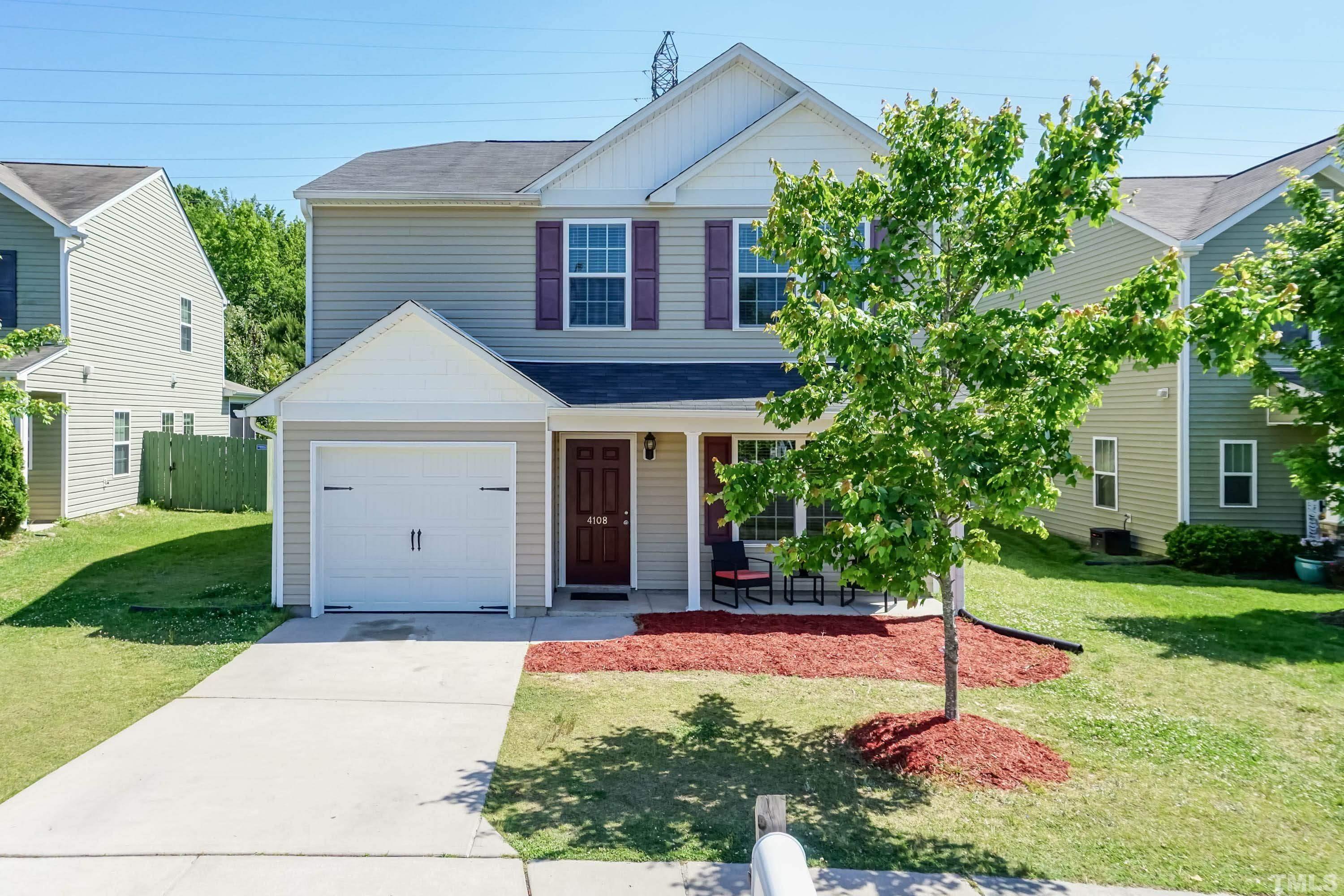 4108 Lady Slipper Lane Durham, NC 27704 - Photo 1 of 33 a front view of a house with a yard and garage