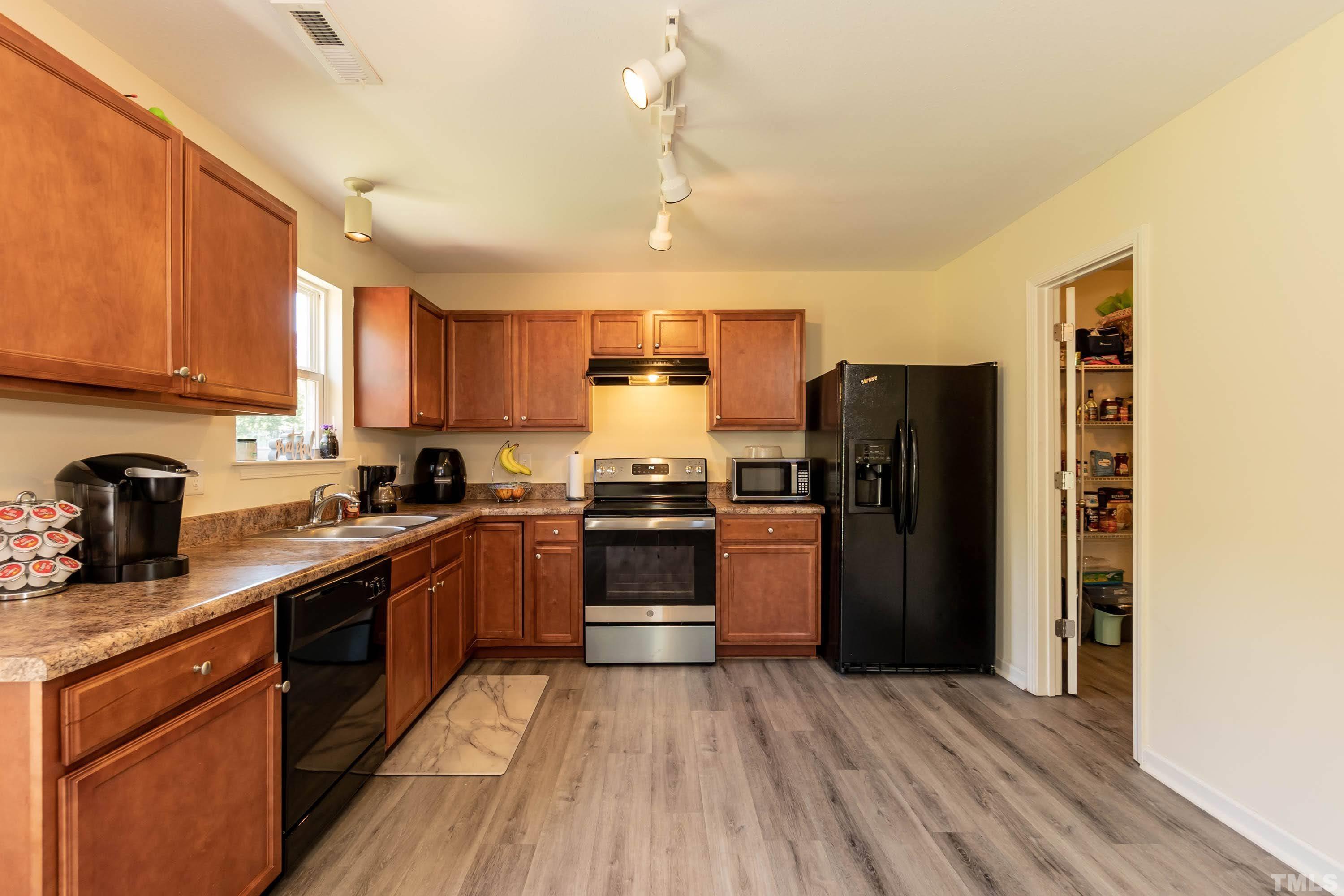 4108 Lady Slipper Lane Durham, NC 27704 - Photo 11 of 33 a kitchen with a refrigerator stove top oven and sink