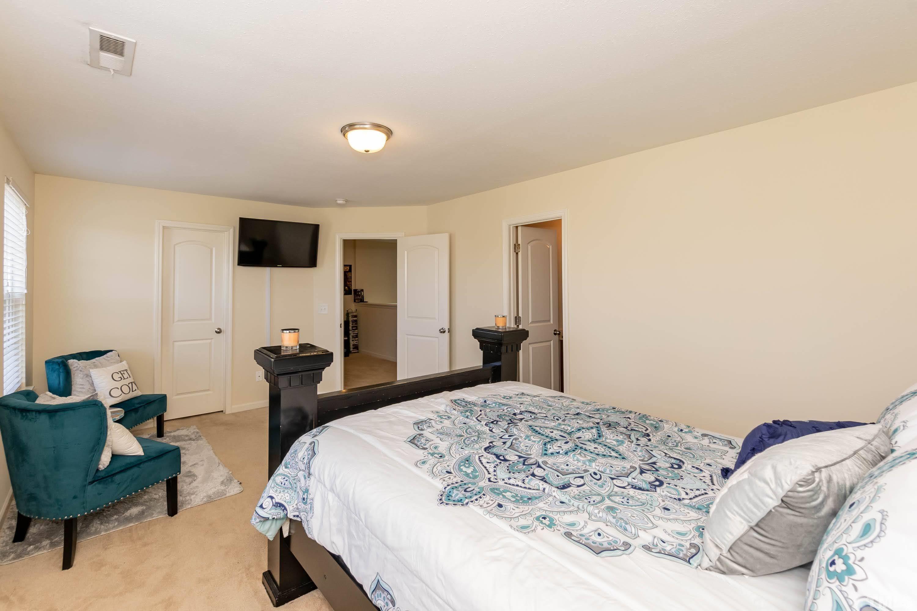 4108 Lady Slipper Lane Durham, NC 27704 - Photo 20 of 33 a bedroom with a bed and a chair