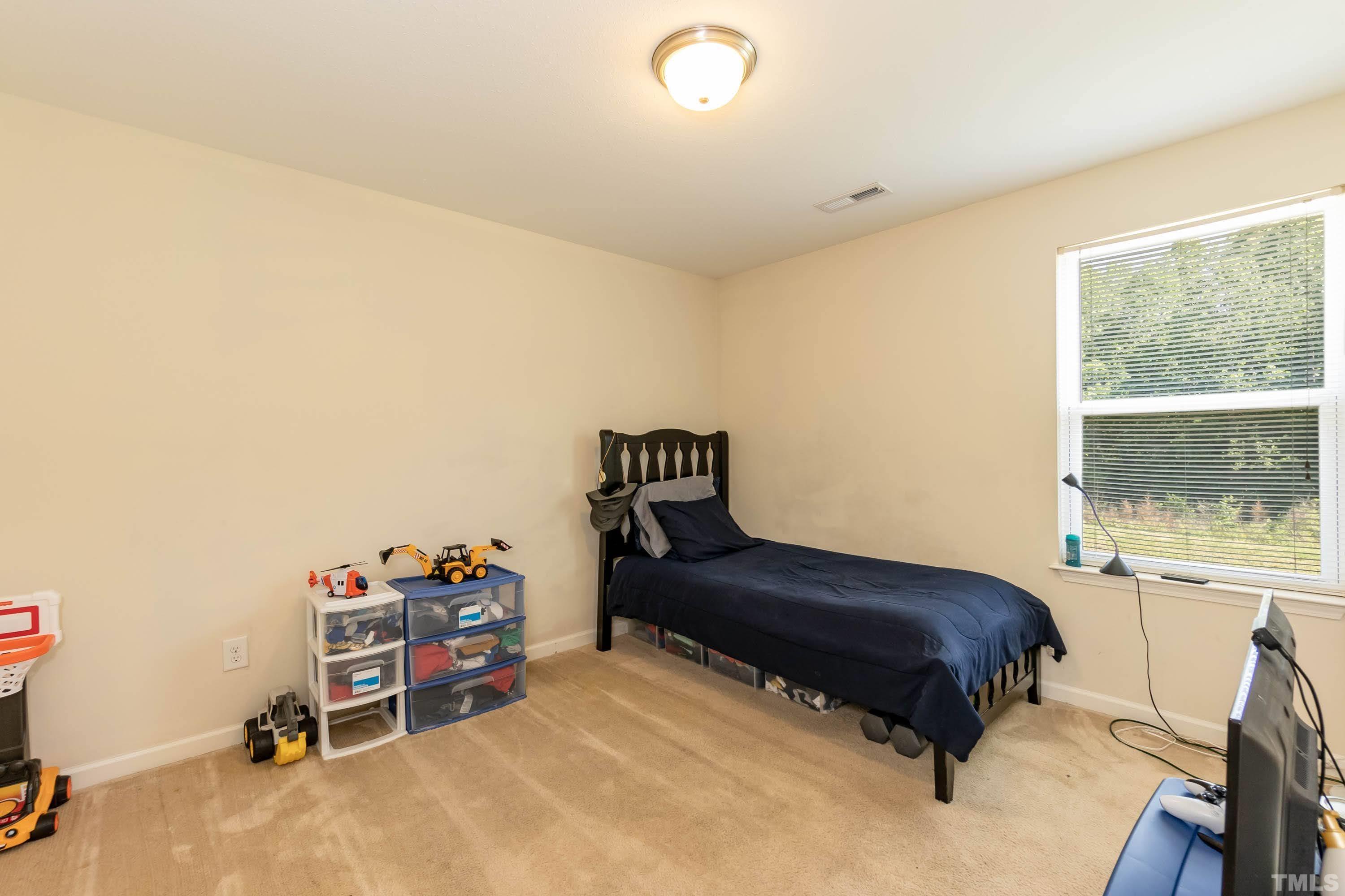 4108 Lady Slipper Lane Durham, NC 27704 - Photo 24 of 33 a bedroom with a bed and a window
