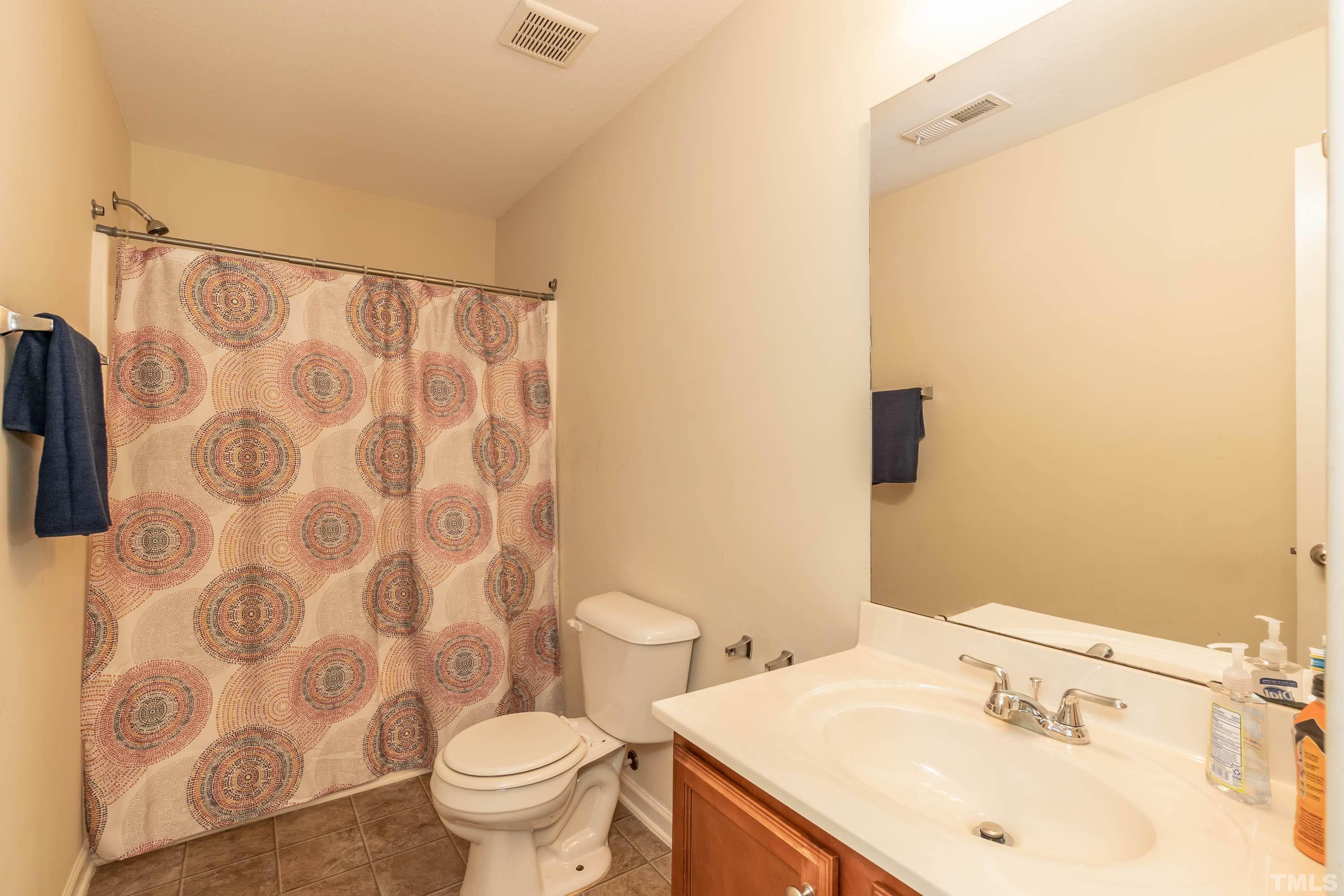 4108 Lady Slipper Lane Durham, NC 27704 - Photo 25 of 33 a bathroom with a sink and a mirror