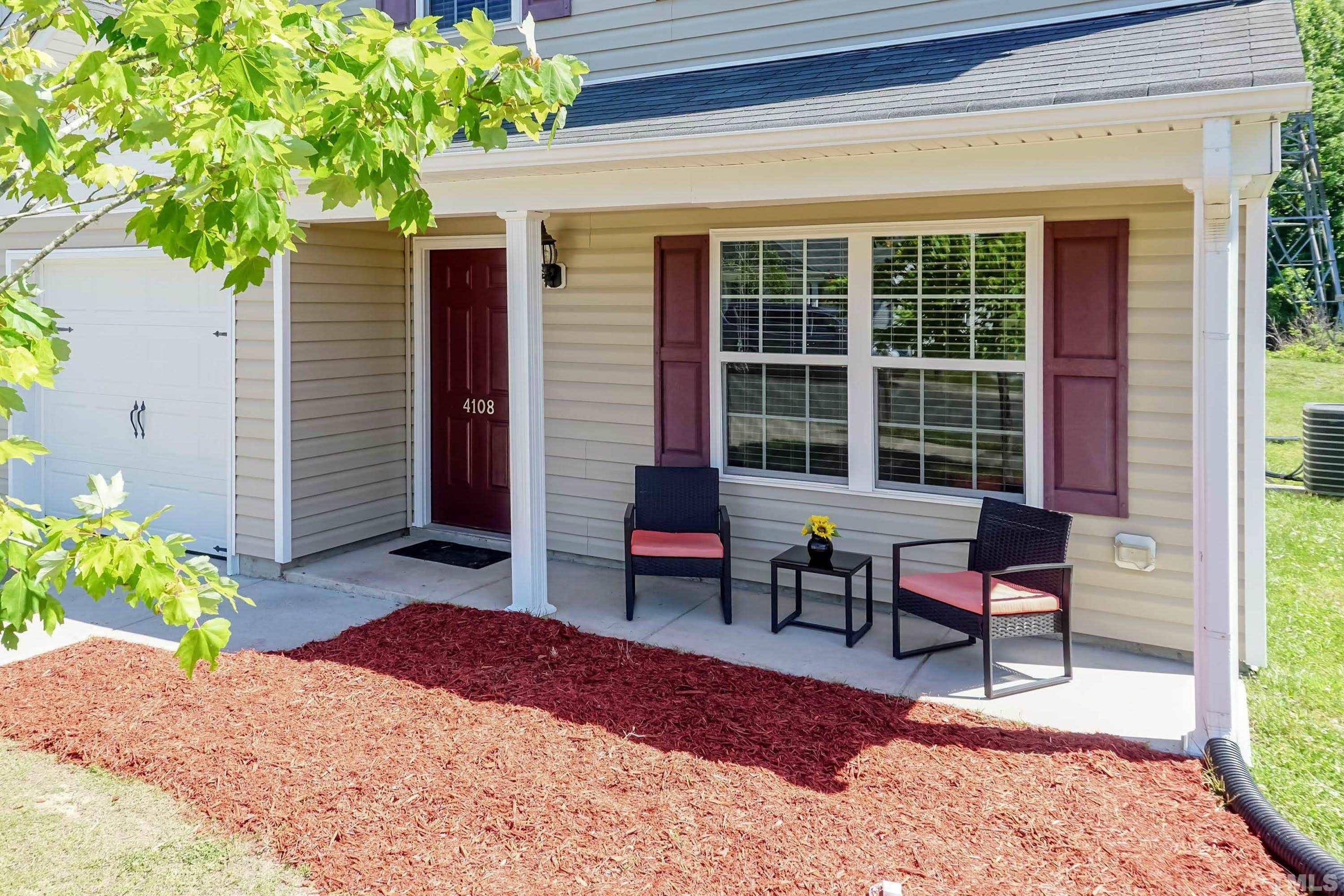 4108 Lady Slipper Lane Durham, NC 27704 - Photo 31 of 33 a balcony with table and chairs and potted plants