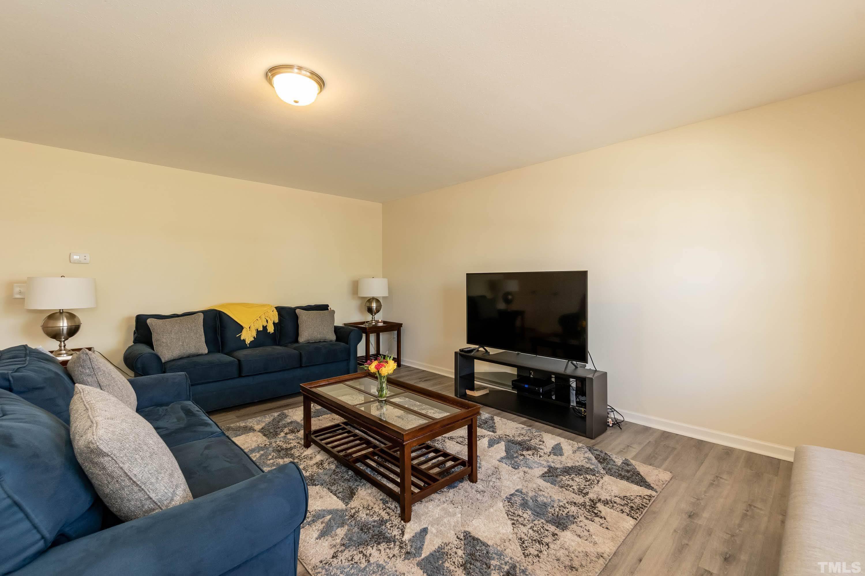 4108 Lady Slipper Lane Durham, NC 27704 - Photo 5 of 33 a living room with furniture and a flat screen tv