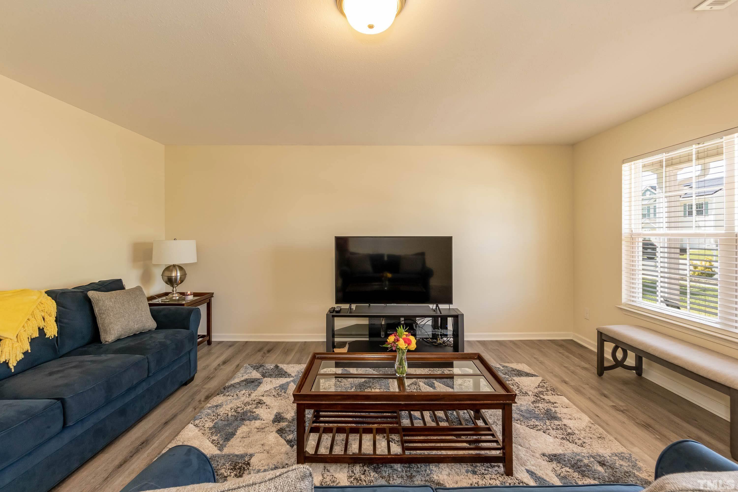 4108 Lady Slipper Lane Durham, NC 27704 - Photo 6 of 33 a living room with furniture and a flat screen tv