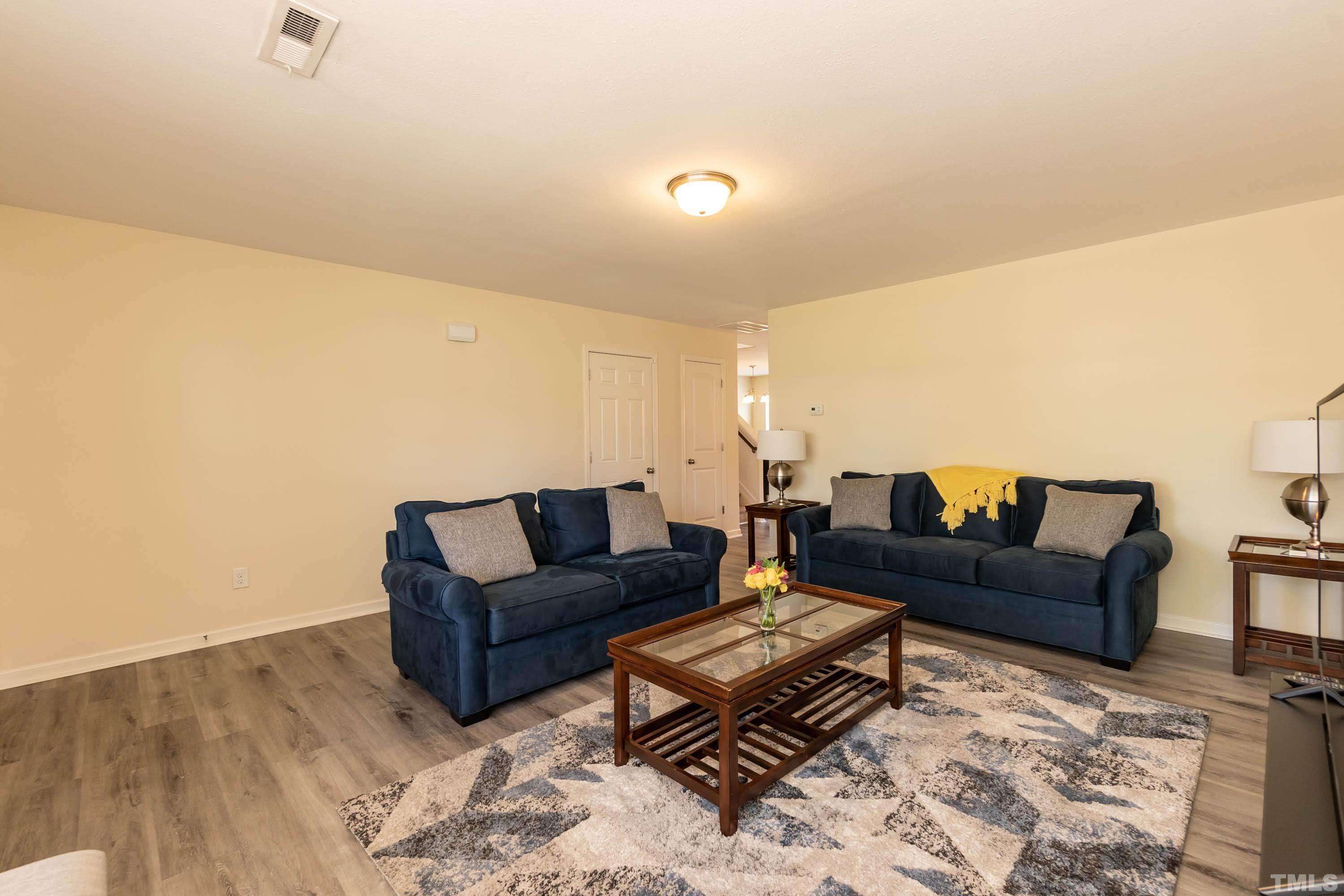 4108 Lady Slipper Lane Durham, NC 27704 - Photo 7 of 33 a living room with furniture and a wooden floor