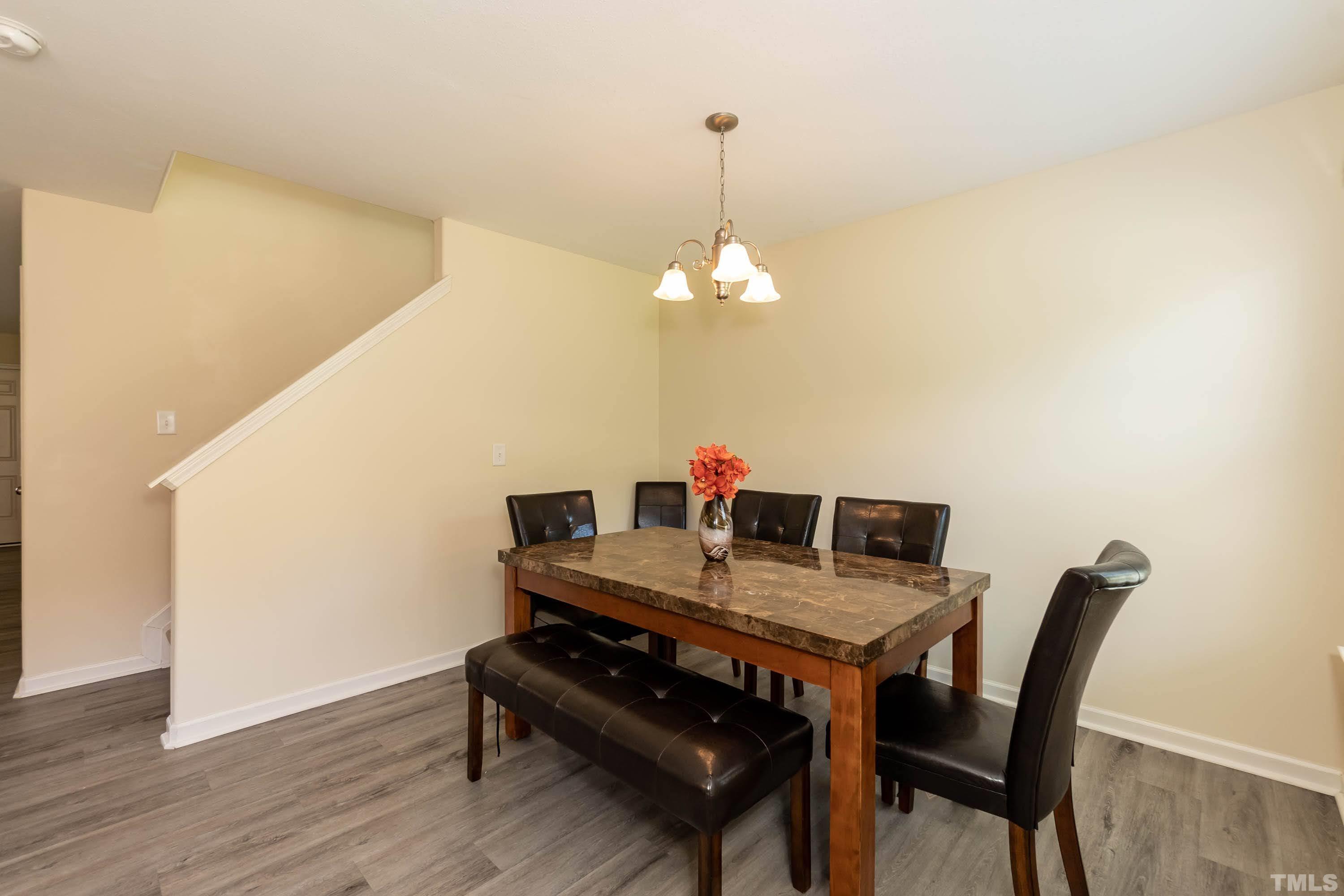 4108 Lady Slipper Lane Durham, NC 27704 - Photo 9 of 33 a view of a dining room with furniture and wooden floor