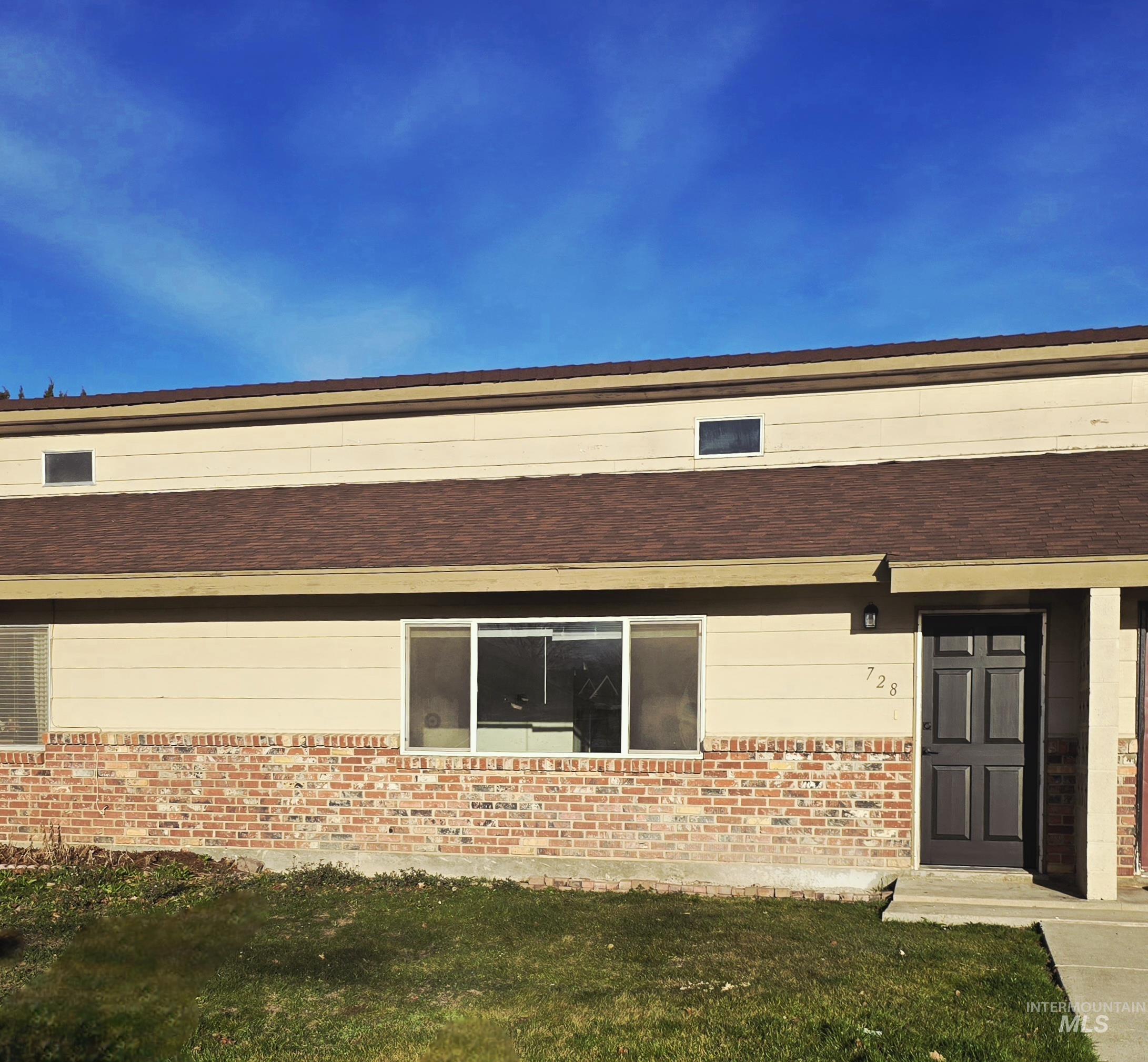 728 Northwest 8th Street Meridian, ID 83642 - Photo 18 of 18 View of exterior entry featuring a yard and brick siding