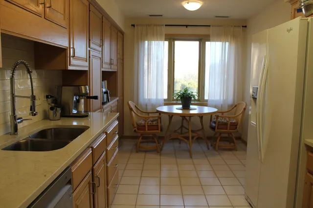 a kitchen with a sink and a refrigerator