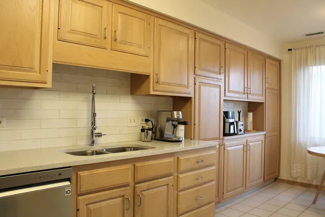 a kitchen with sink cabinets and appliances