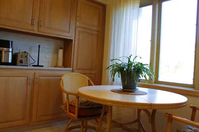a dining room with furniture and wooden floor