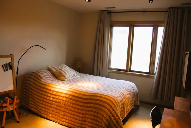 a bedroom with a bed and a window