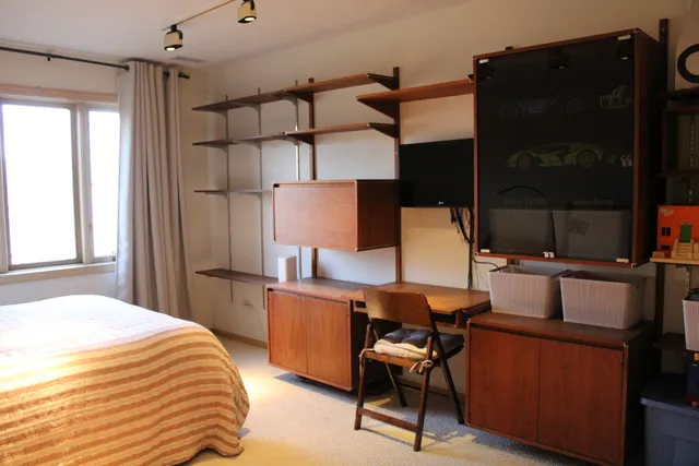 a bedroom with a bed and a closet