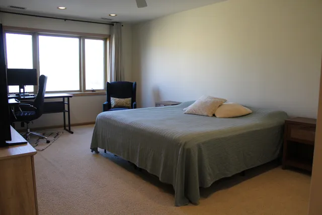 a bedroom with a bed and a window