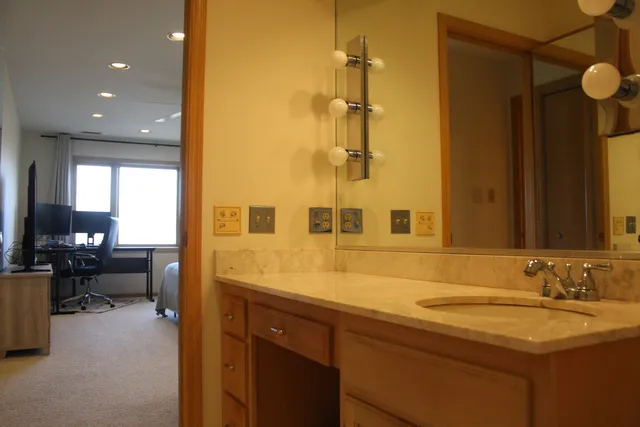 a bathroom with a sink a toilet and a mirror
