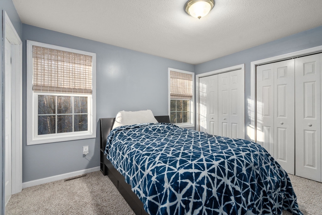 89 Jarvis Avenue Holyoke, MA 01040 - Photo 17 of 27 a bedroom with a bed and windows